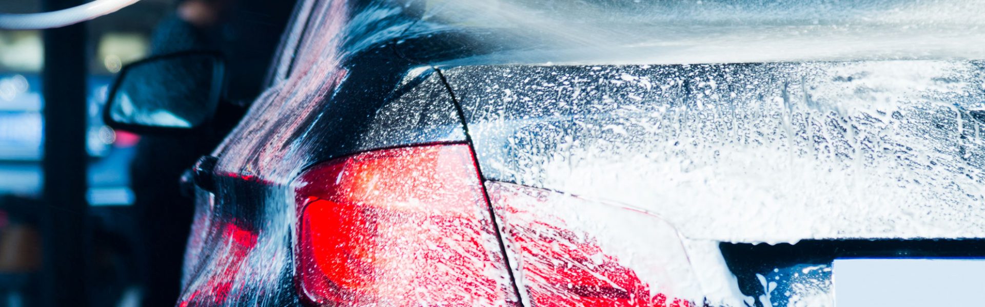 Car wash with flowing water and foam.